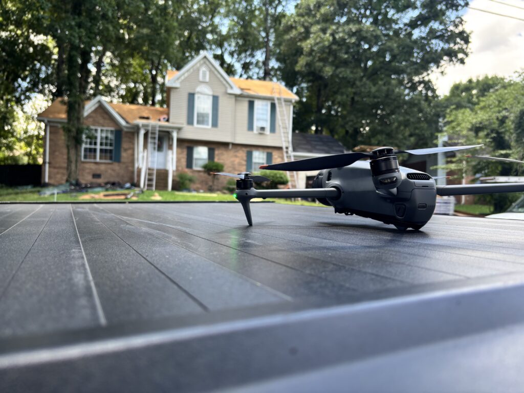 Roofing inspection drone on a rooftop in front of a Tennessee home, used for AI roof inspection
