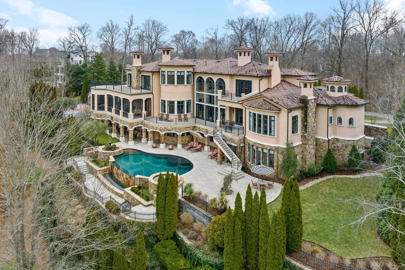 Aerial drone view of a large Brentwood TN home with a tile roof