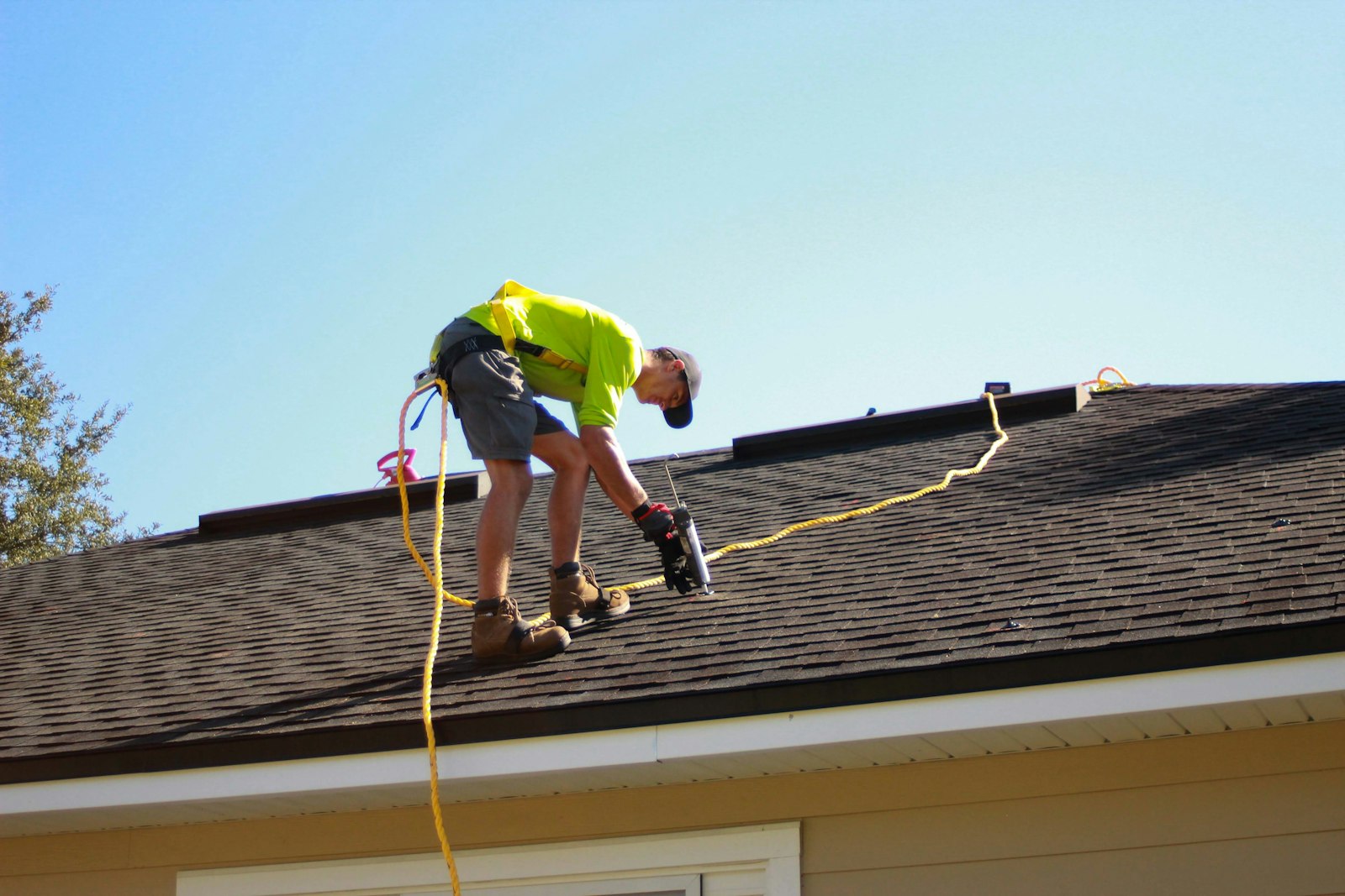 Roofer repairing a roof leak on a Nashville home